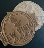 front and back image of embossed leather patch by Custom Couture Label Company
